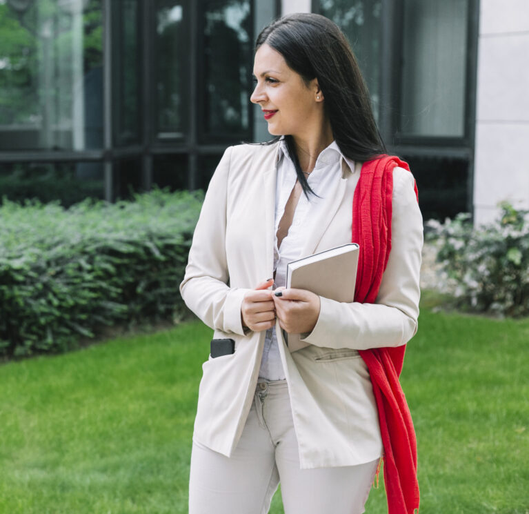 professional-businesswoman-with-diary-standing-outside-office-building