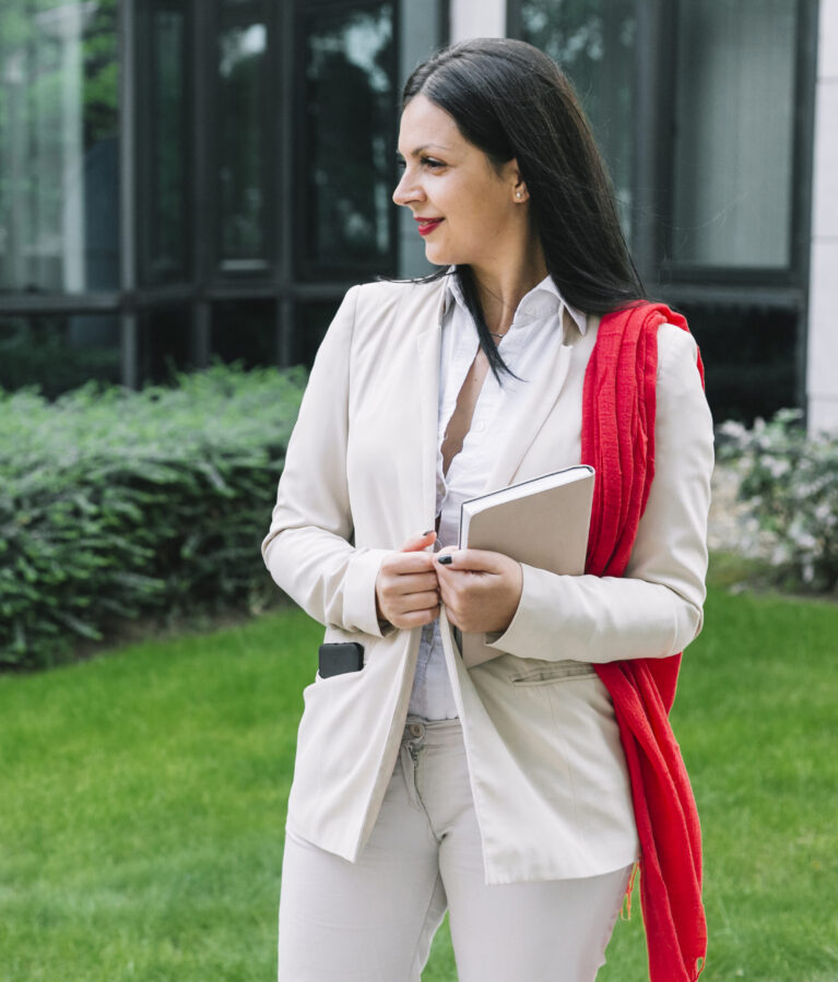 professional-businesswoman-with-diary-standing-outside-office-building