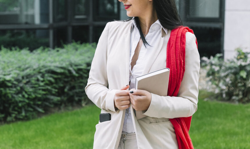 professional-businesswoman-with-diary-standing-outside-office-building